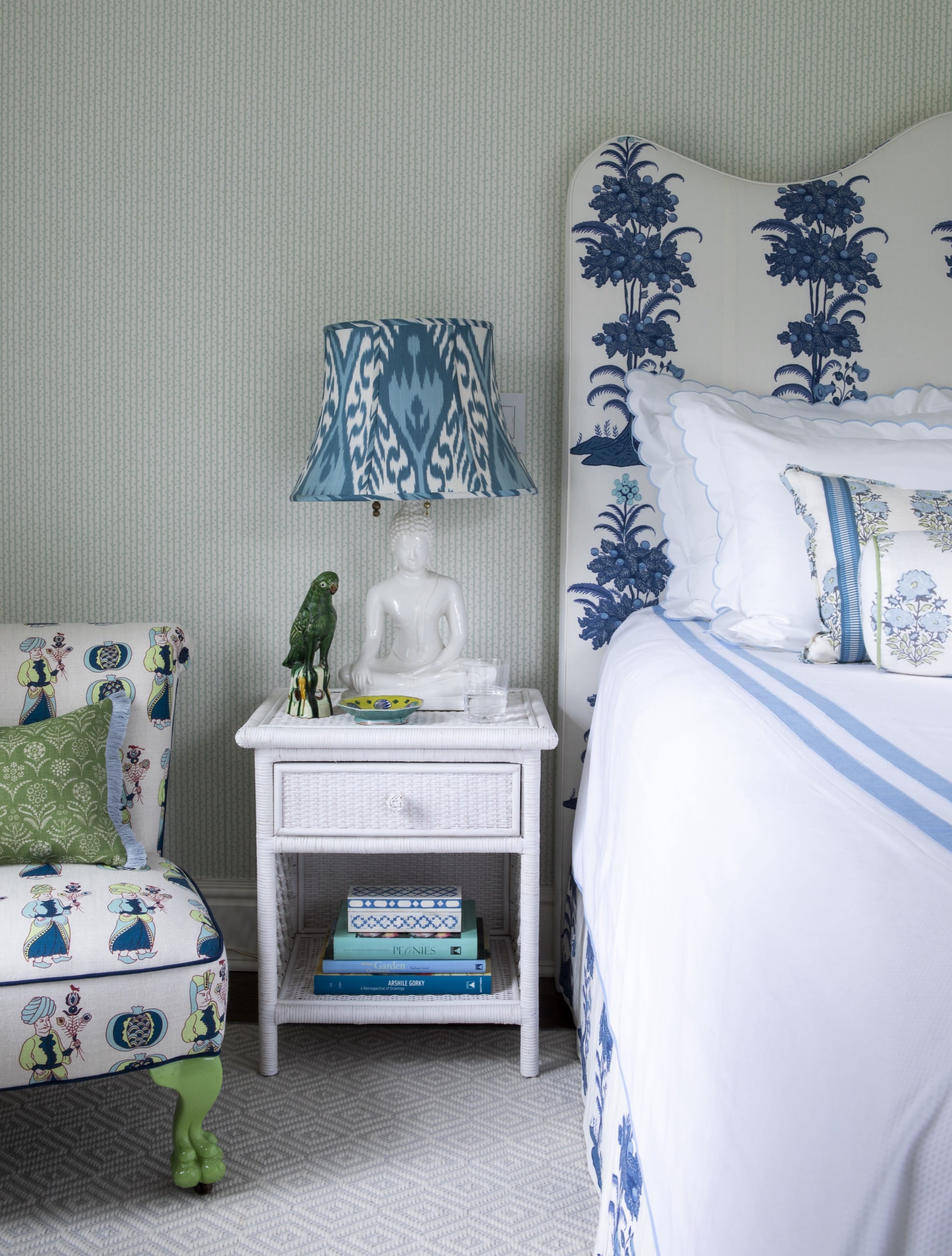 Bedroom with blue and white bedding and lamp.