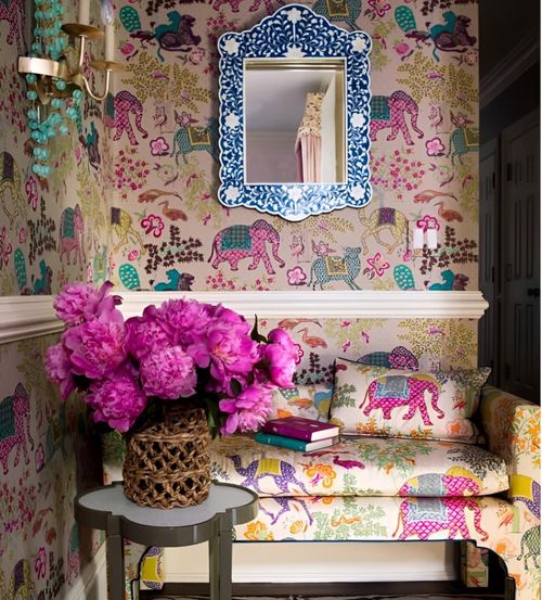 Colorful floral wallpaper with bench and flowers.