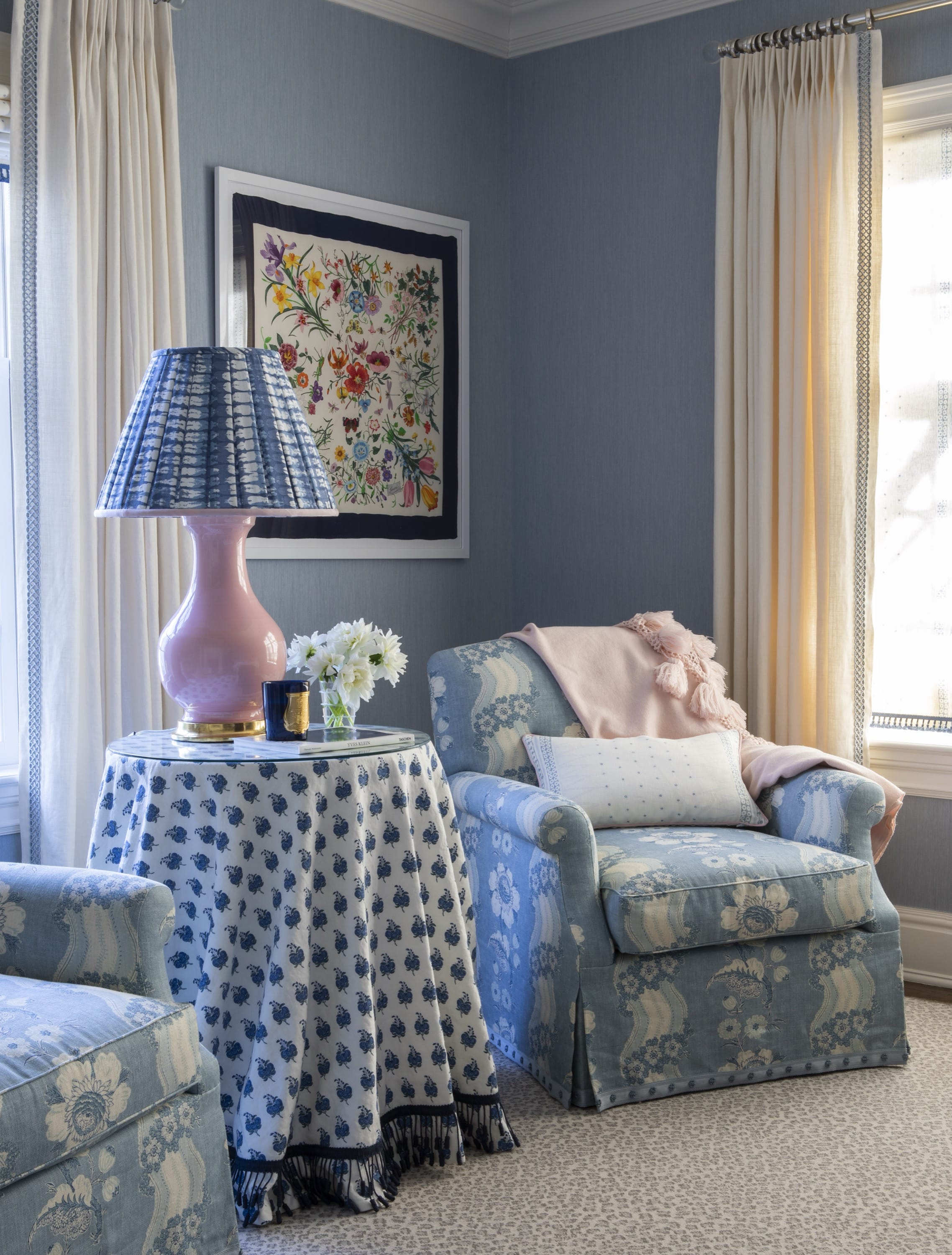 Sitting area with armchair, ottoman, and lamp.