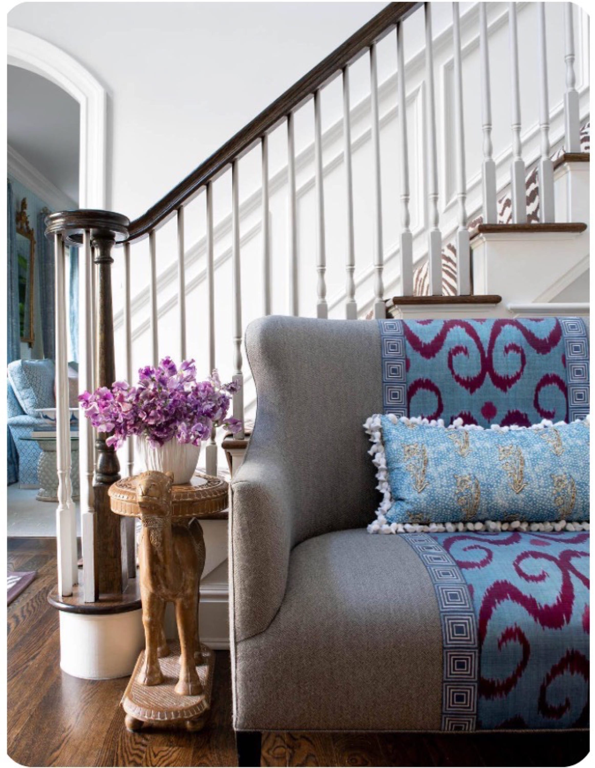 	Staircase landing with patterned bench and pillows.