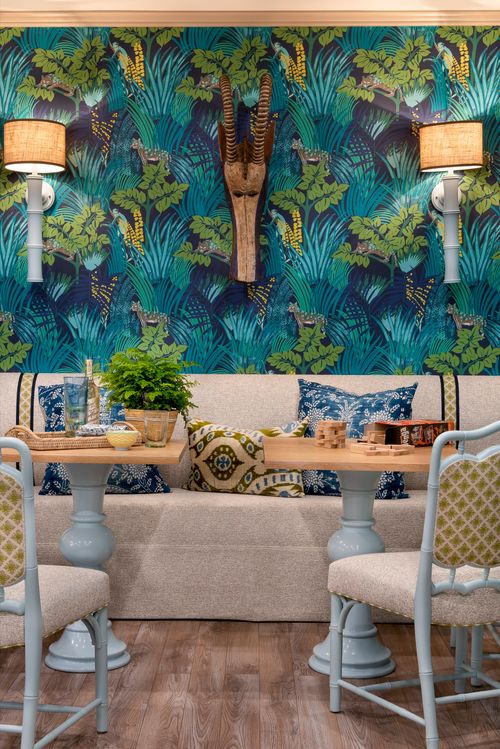 Room with bold tropical wallpaper and sofa.