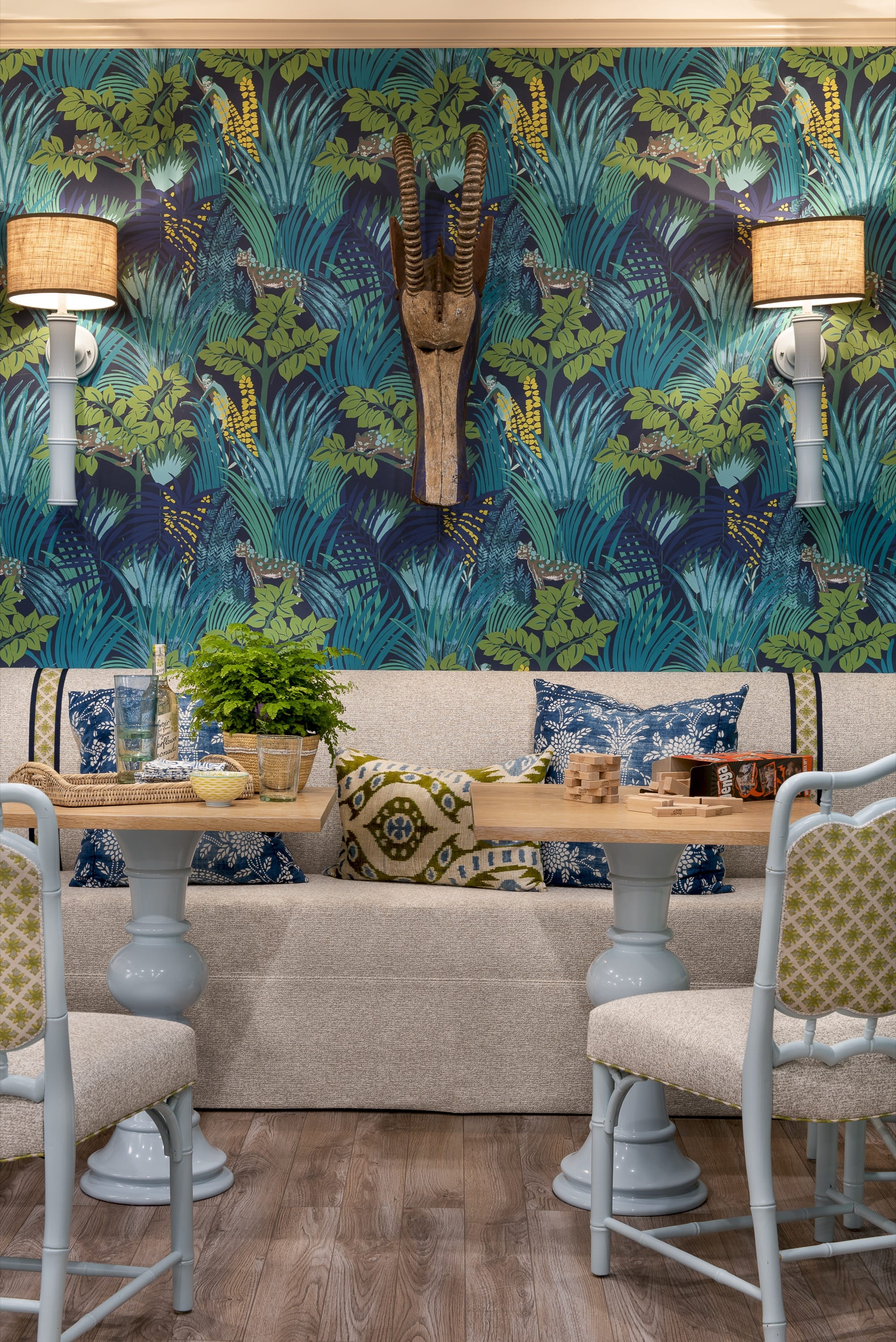 Room with bold tropical wallpaper and sofa.