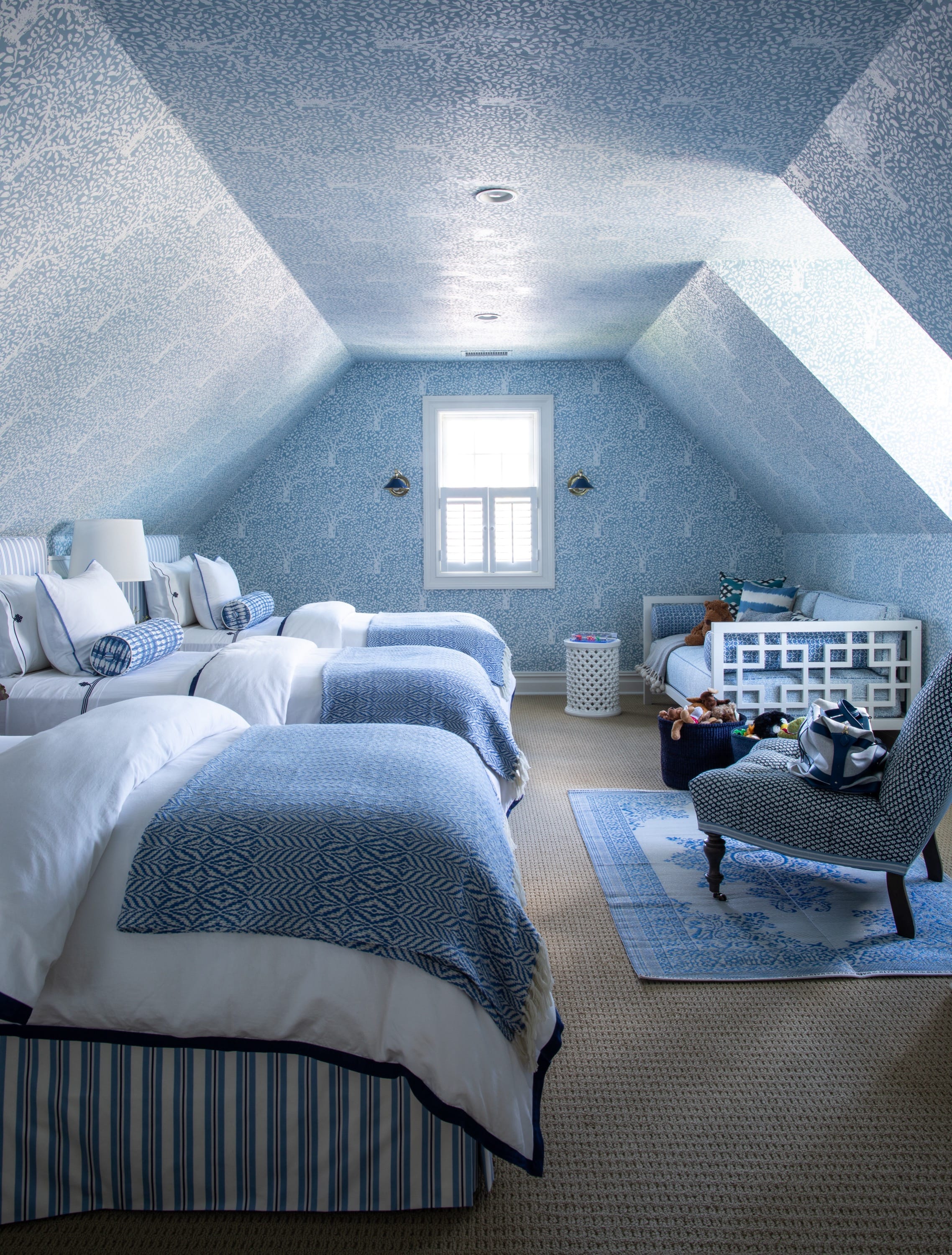 Attic lounge with sofas under dormer window.