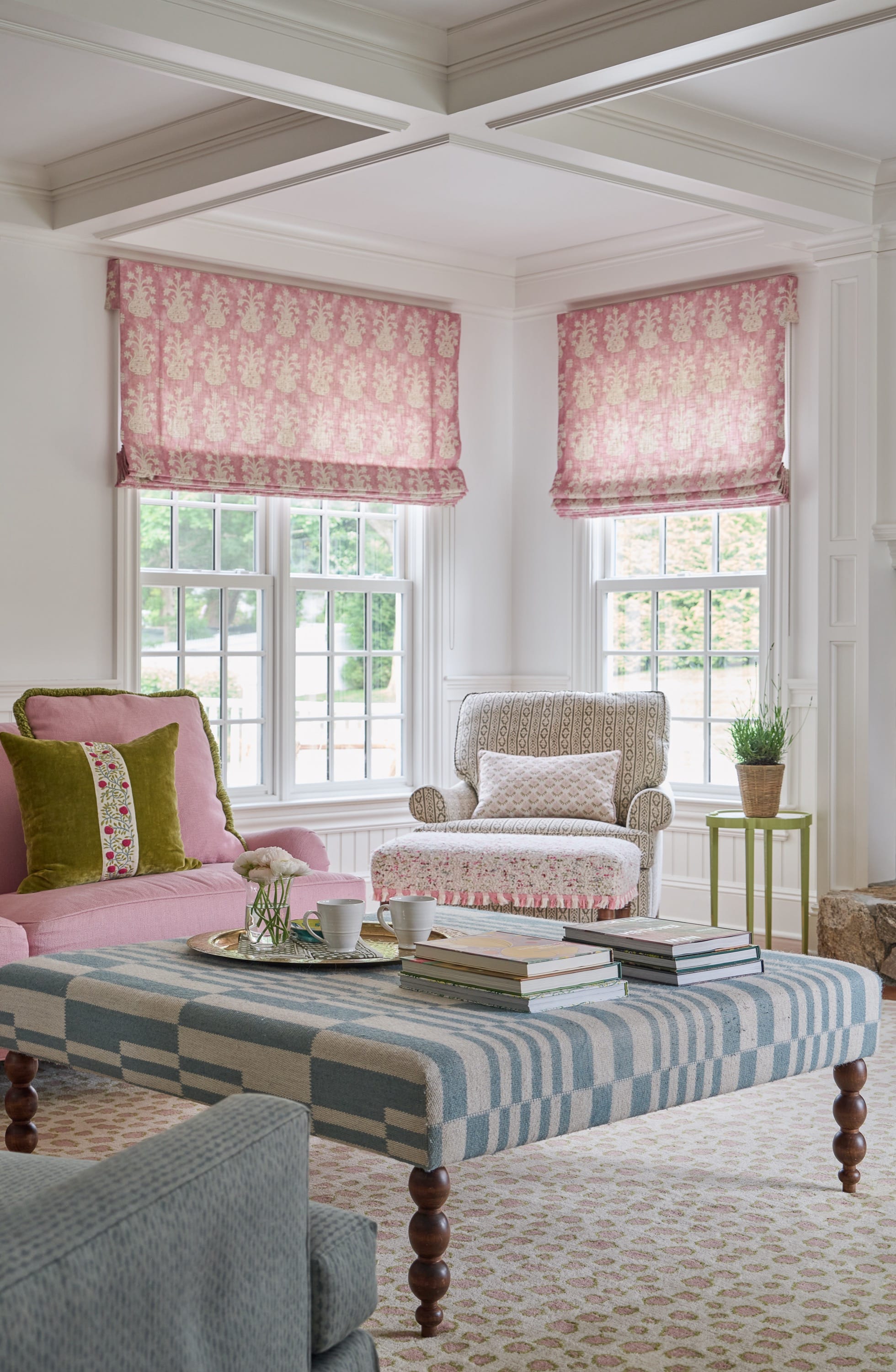 Bright living room with pink sofa and ottoman.
