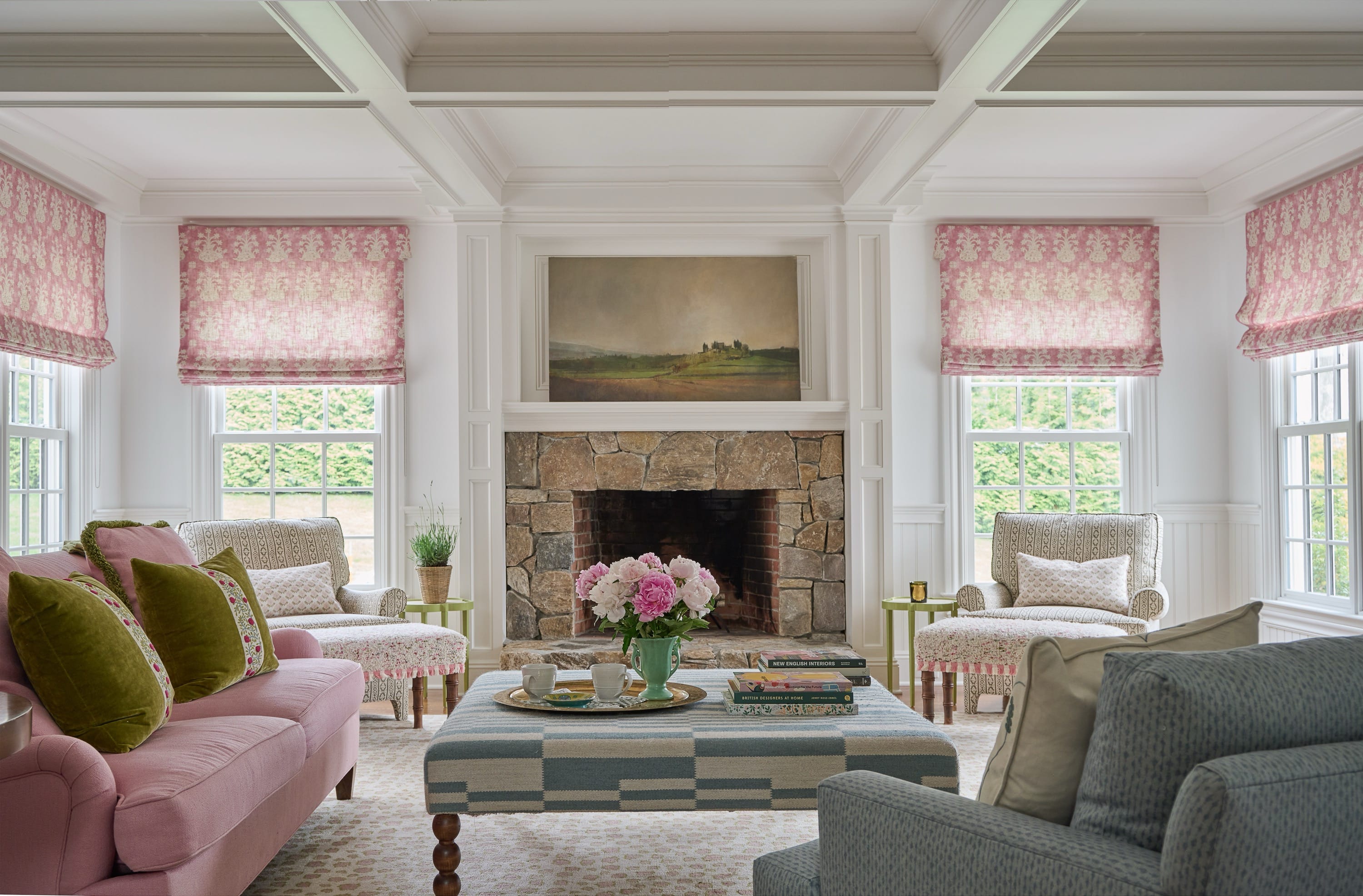 Living room with fireplace, pink sofa, and gray chairs.