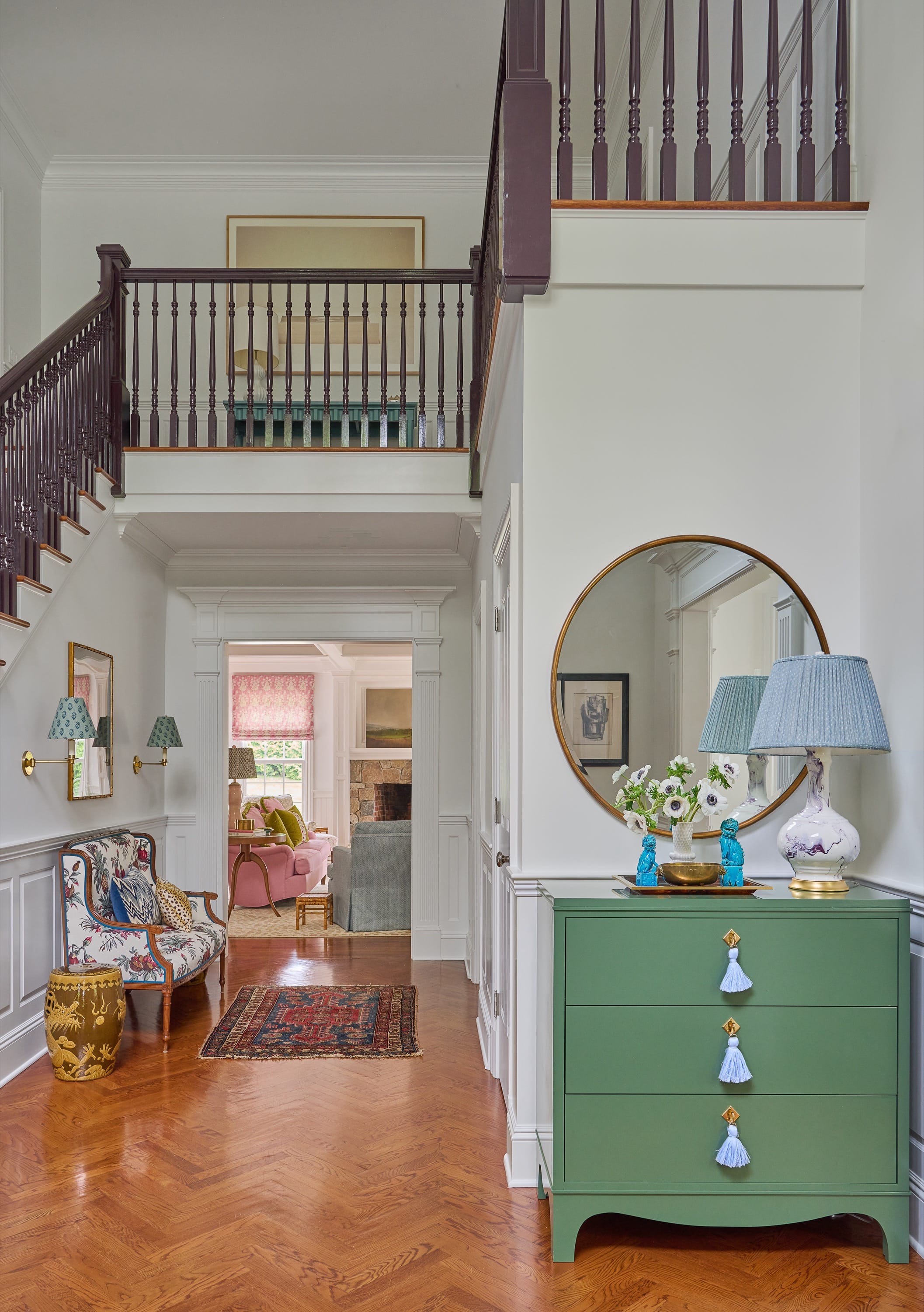 Entryway with staircase and green console table.