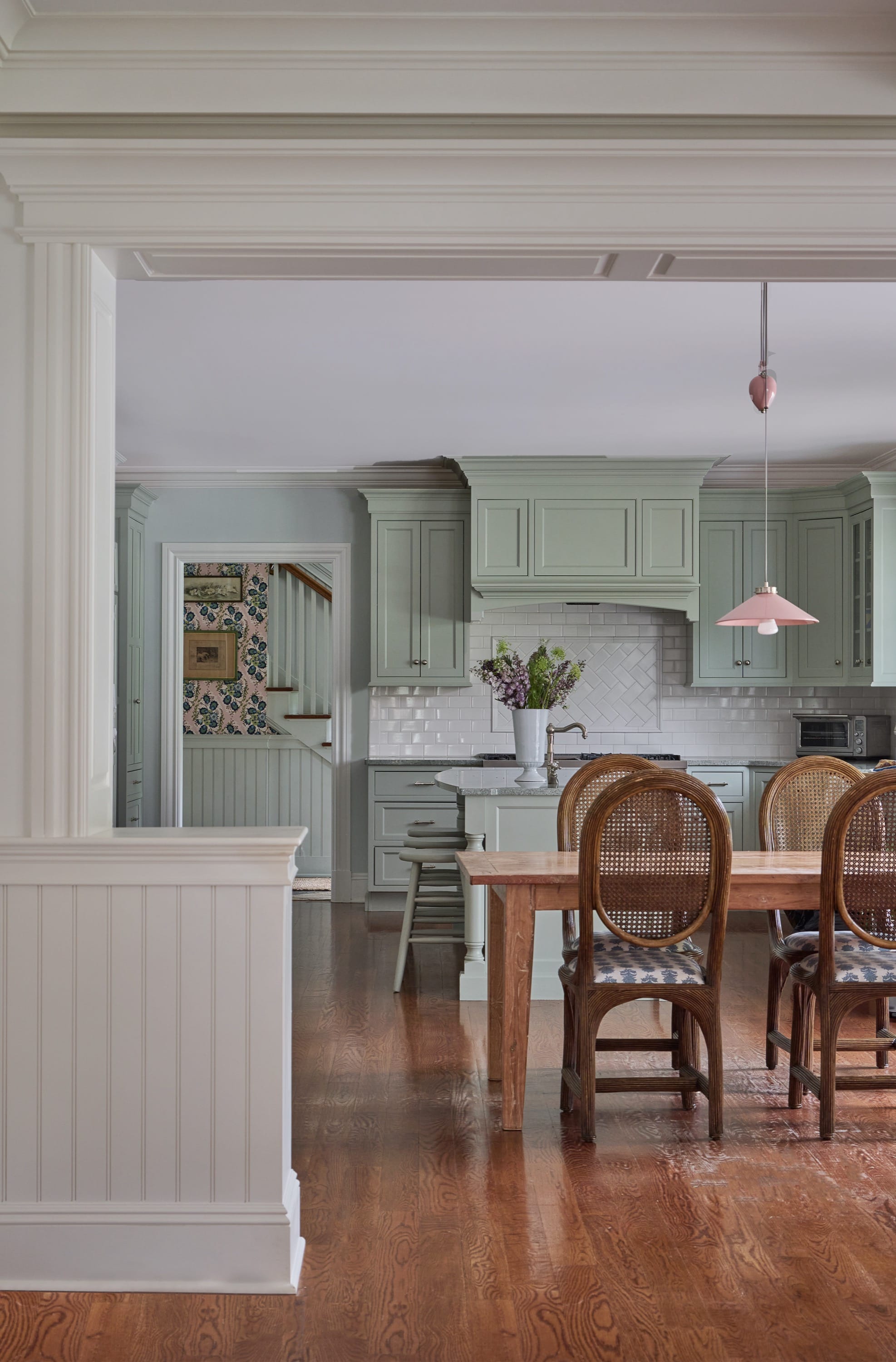 Kitchen view with wooden table and chairs.