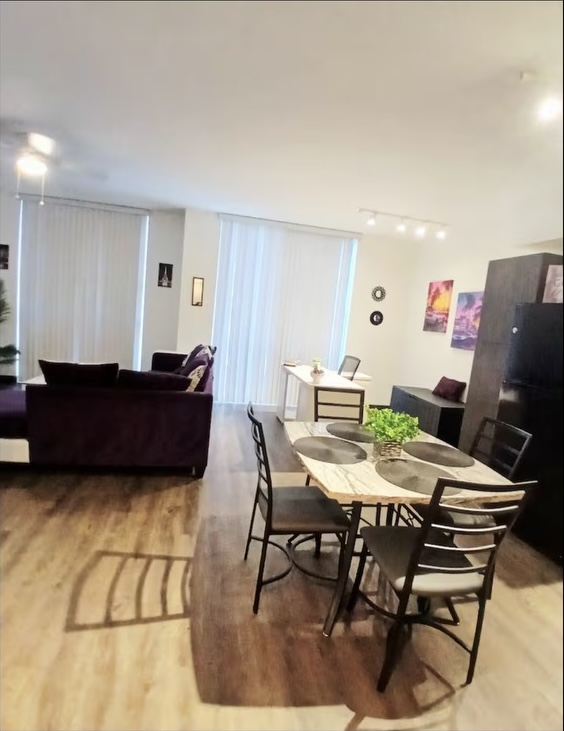 Kitchen with table and view of living area