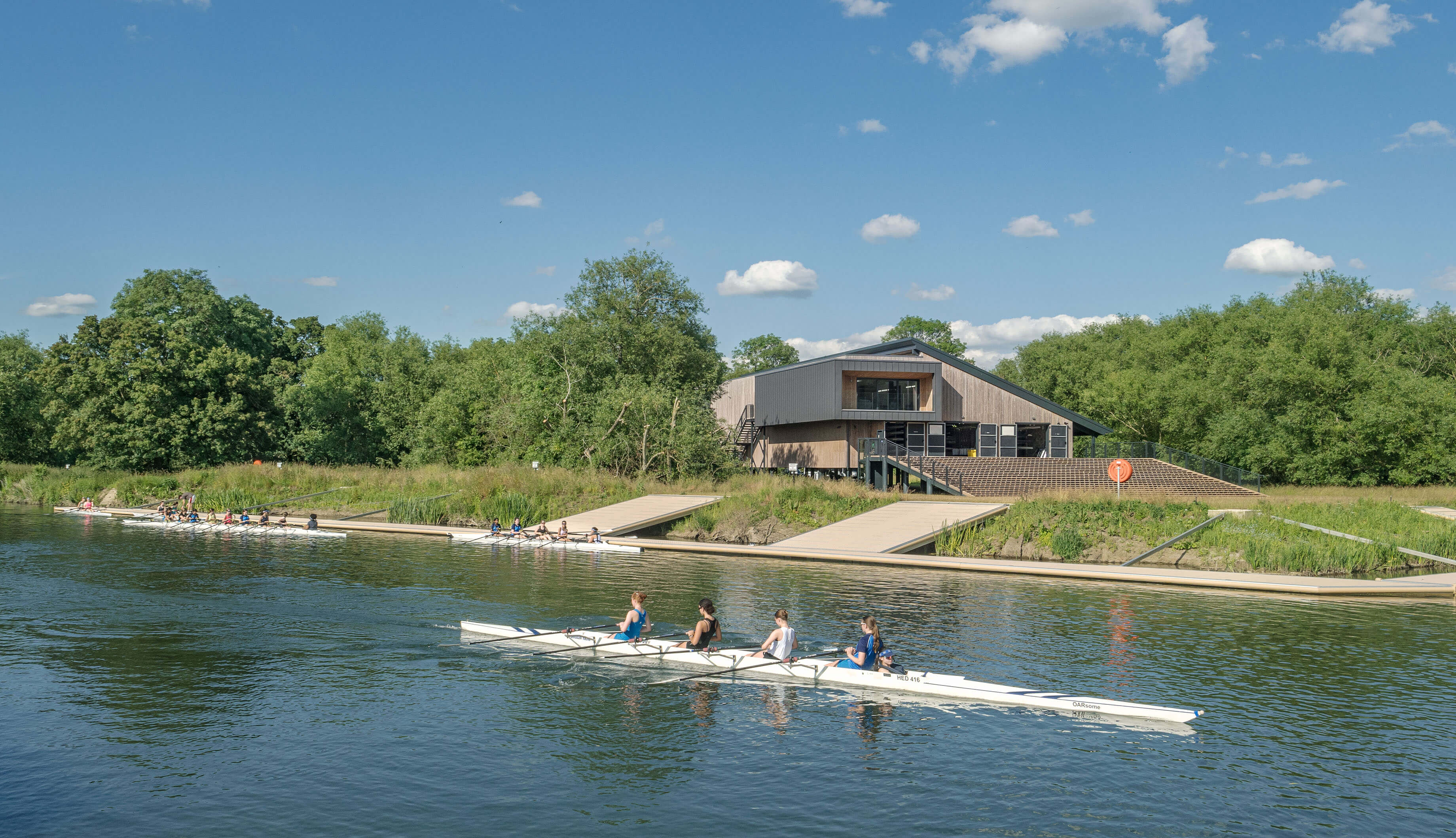 Photo of the project along the river, with a kayak at the front on the river