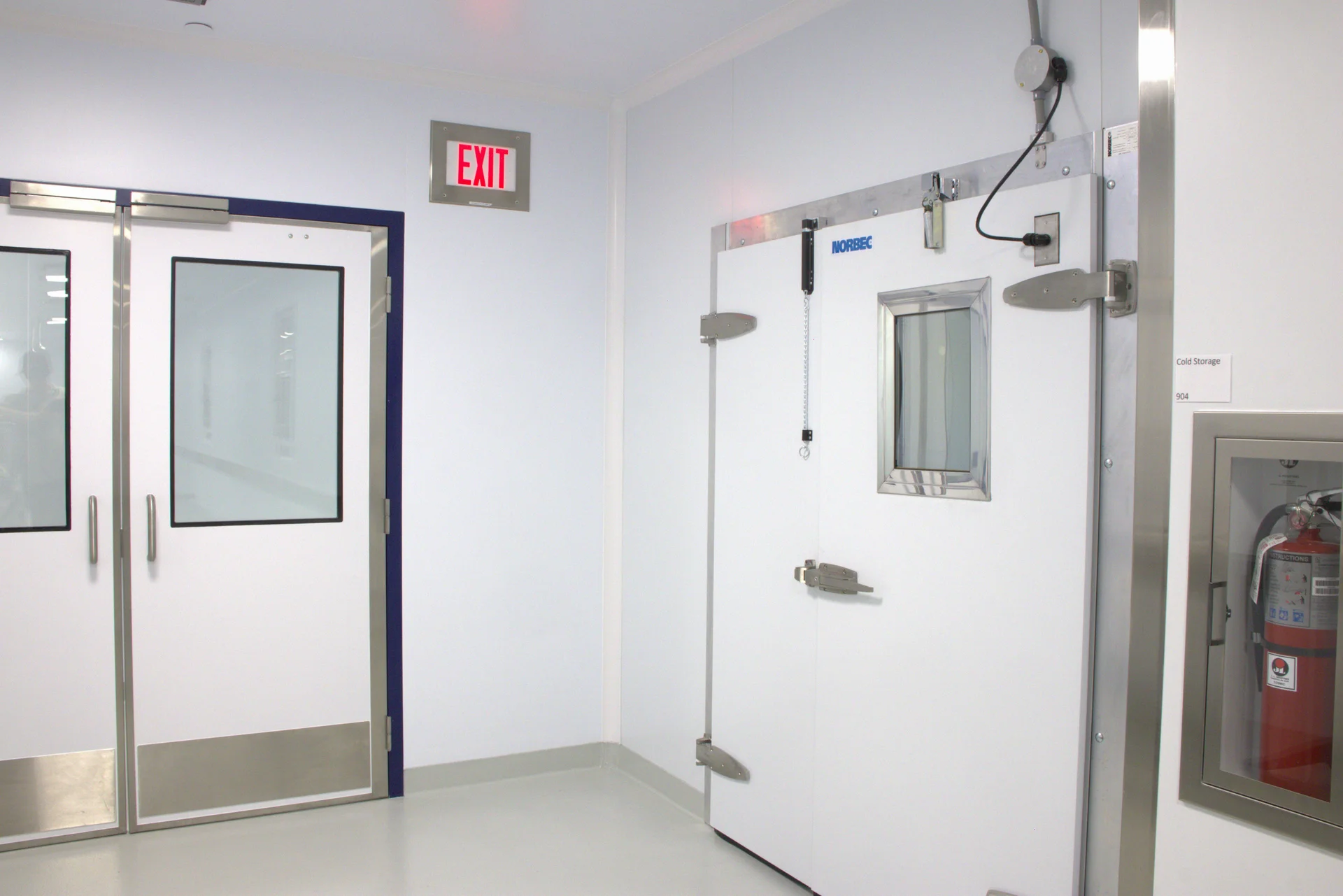 Illustrated rendering of a modular cleanroom facility, designed for use in biopharmaceutical or advanced manufacturing environments. The layout includes multiple segregated entry and operational zones, each with flush doors and vision panels for visibility and contamination control. The structure features cleanroom-grade wall panels. The modular design allows for rapid deployment, scalability, and compliance with ISO or GMP standards, making it ideal for clean environments such as gene therapy, cell therapy, or sterile fill-finish operations.