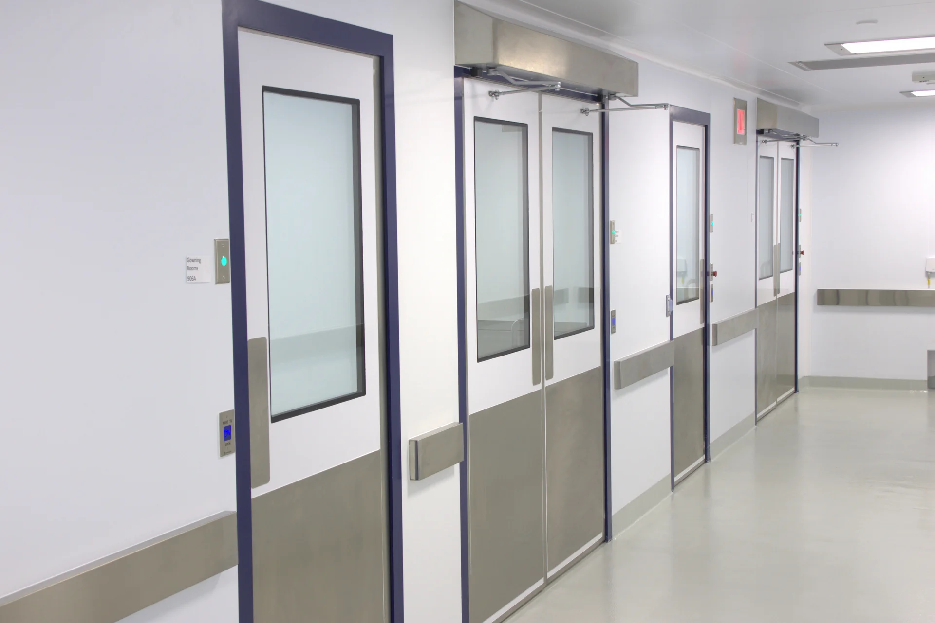 Illustrated rendering of a modular cleanroom facility, designed for use in biopharmaceutical or advanced manufacturing environments. The layout includes multiple segregated entry and operational zones, each with flush doors and vision panels for visibility and contamination control. The structure features cleanroom-grade wall panels. The modular design allows for rapid deployment, scalability, and compliance with ISO or GMP standards, making it ideal for clean environments such as gene therapy, cell therapy, or sterile fill-finish operations.