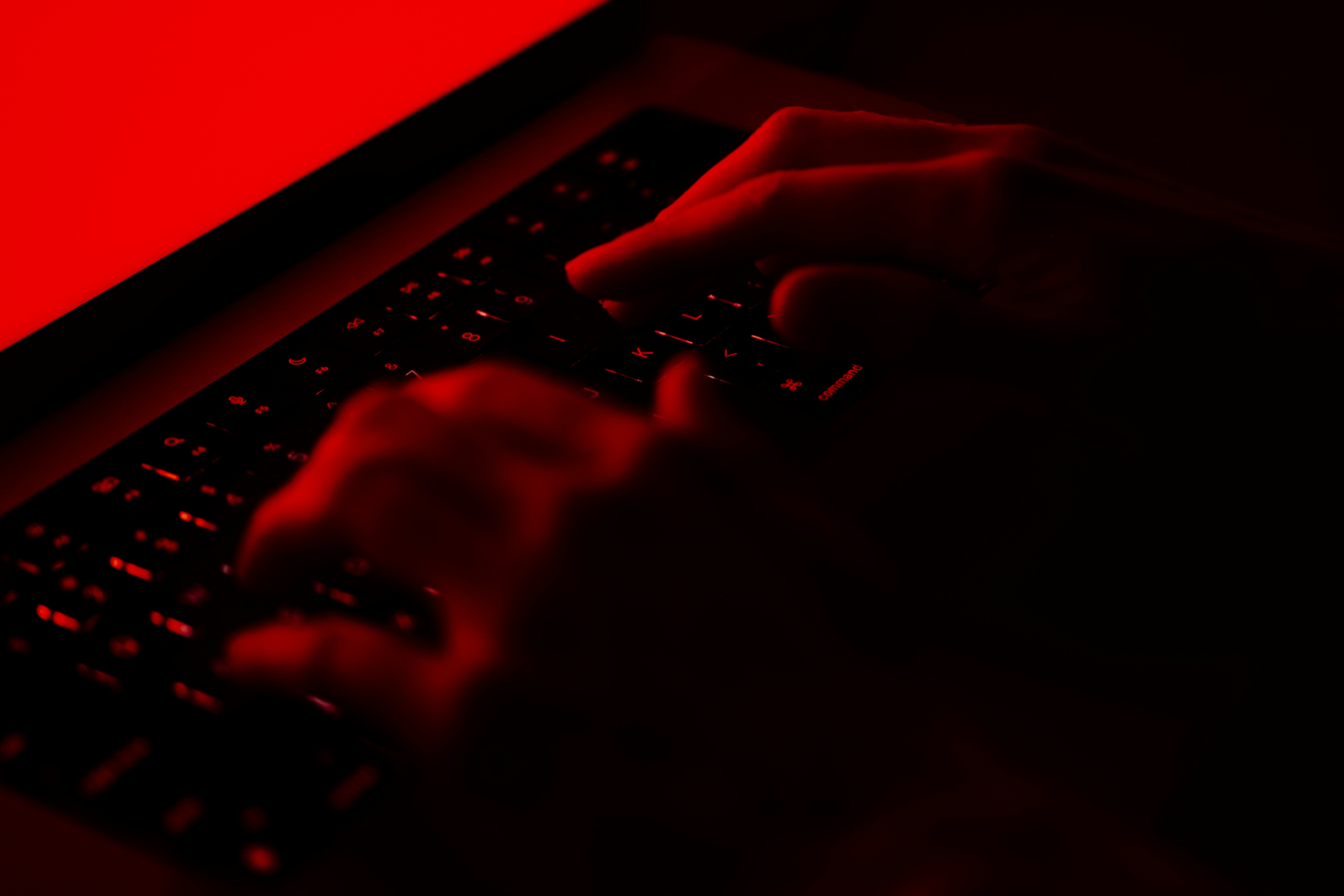 Hacker on red computer screen