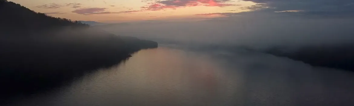 A big lake covered by fog.