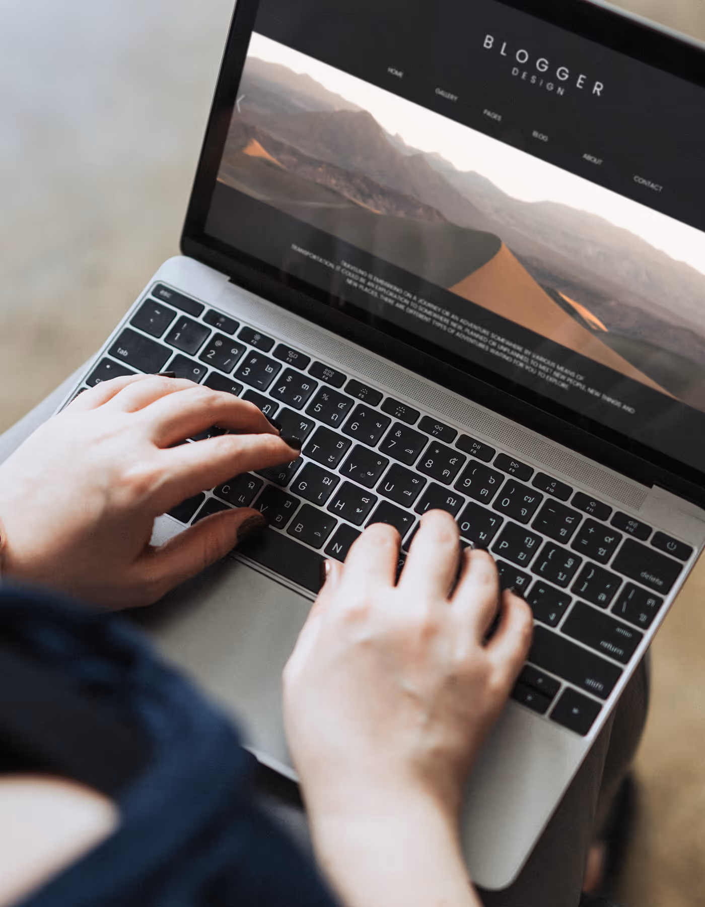 Image of a man using a laptop on his lap