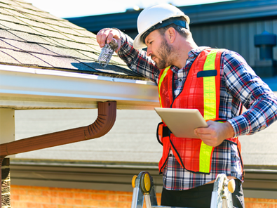 Construction engineers reviewing plans and supervising high-rise building project on-site in Florida