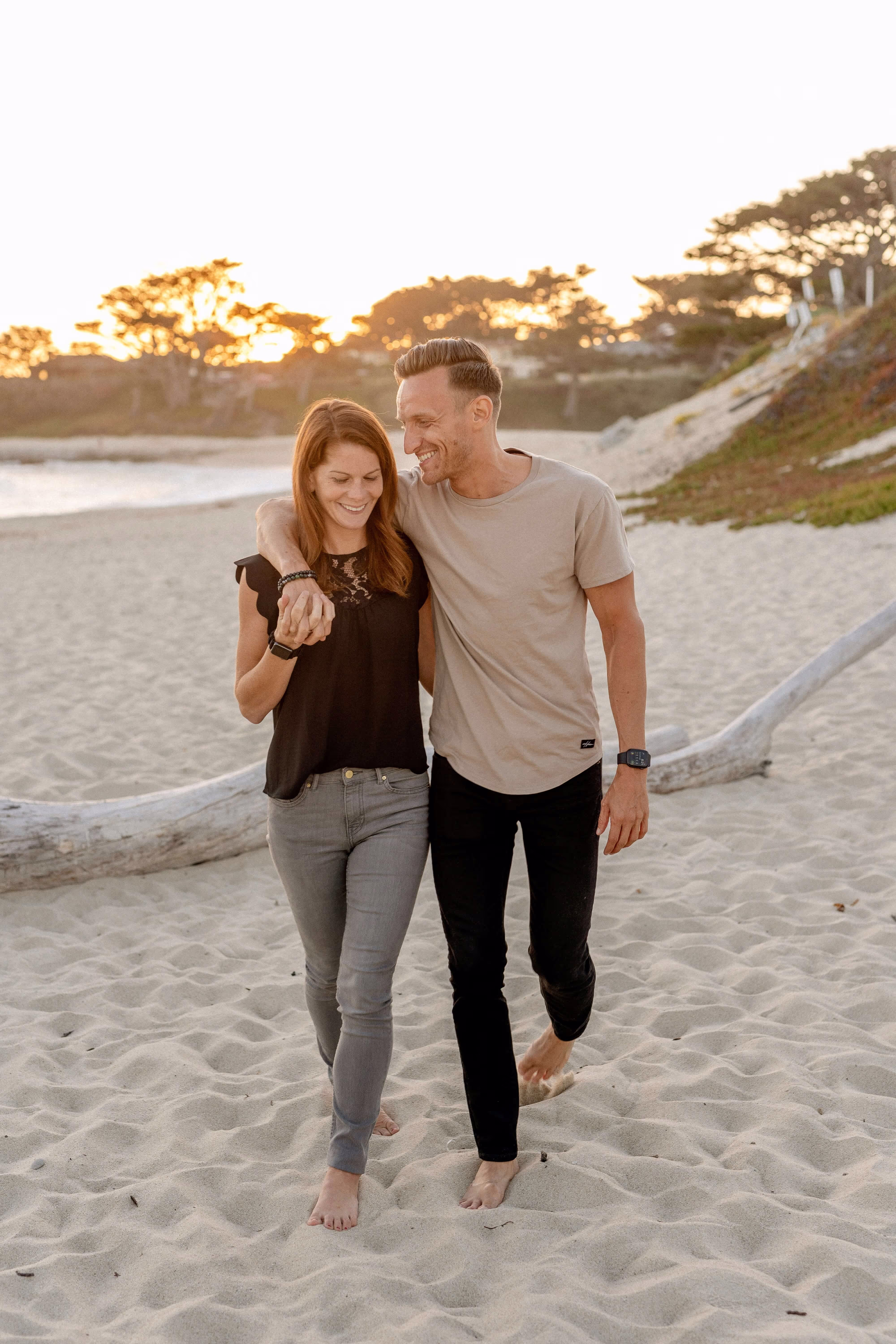 A young couple walking on a beach
