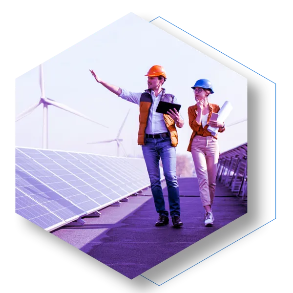 Two researchers with mobile devices waling through a Wind and solar farm
