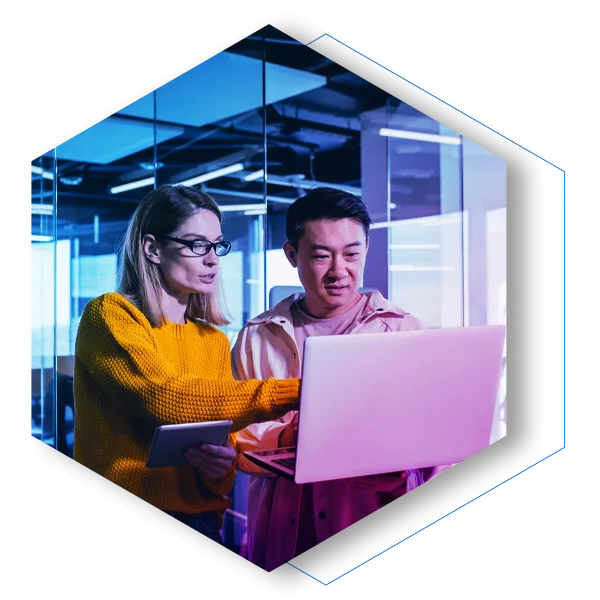 Business meeting of two employees, Asian and female colleagues, discussing the project, working in a modern office, looking at a laptop screen, discussing edits, and project success