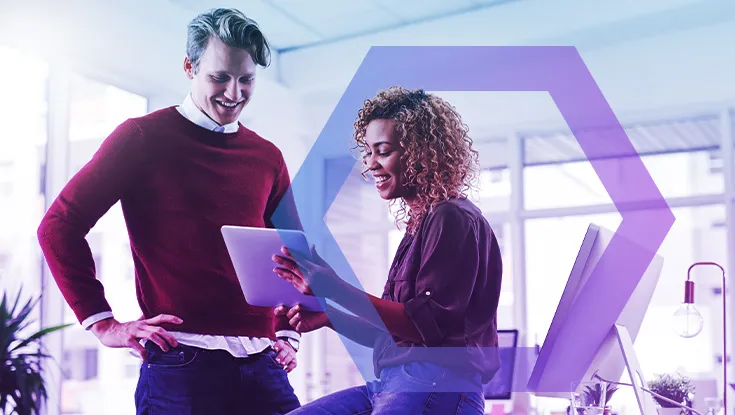 two office workers looking at tablet device

