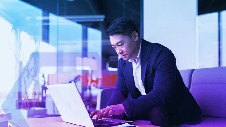 balanced and calm businessman, asian man thinking working at laptop sitting in the office by the window