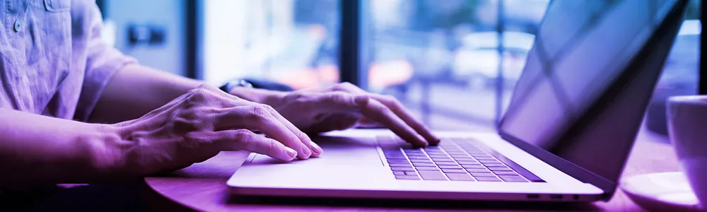 Close up of hands and laptop