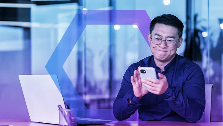 Dissatisfied asian businessman got bad news, man reading on smartphone sitting inside modern office with laptop, disappointed boss with phone upset.
