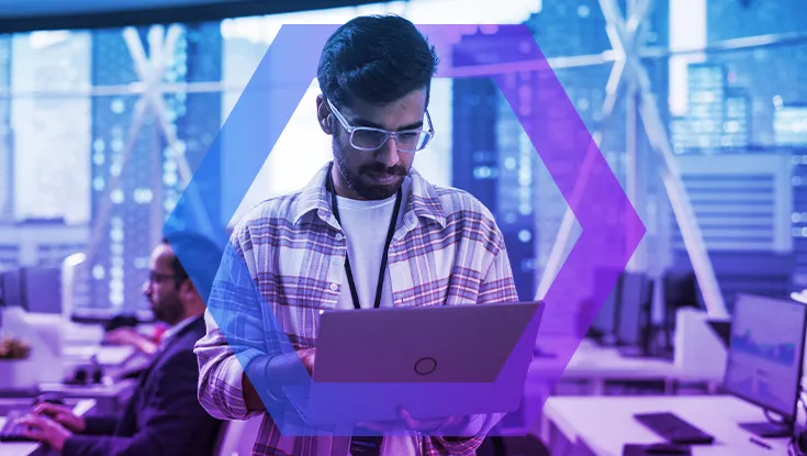 Enterprise office with man with laptop in center
