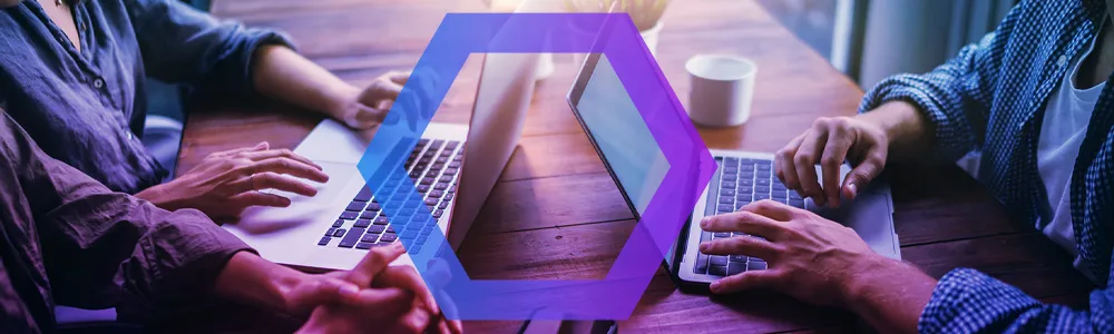 close up horizontal image of two laptops and hands on a table