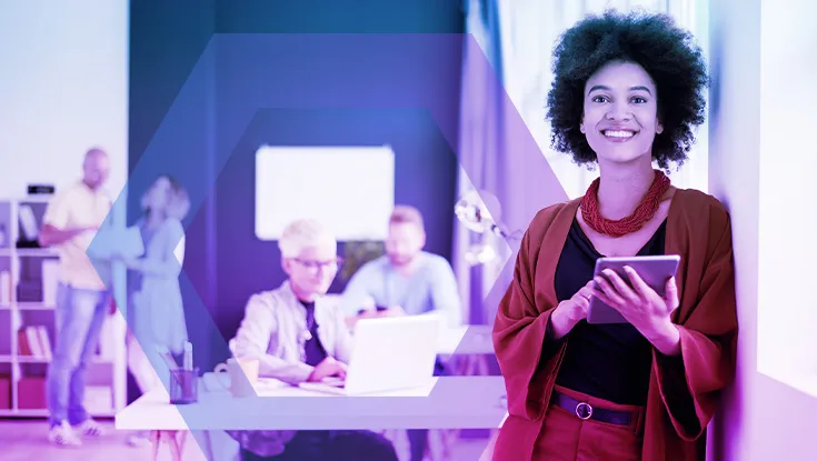 Woman with mobile device in hand standing in office