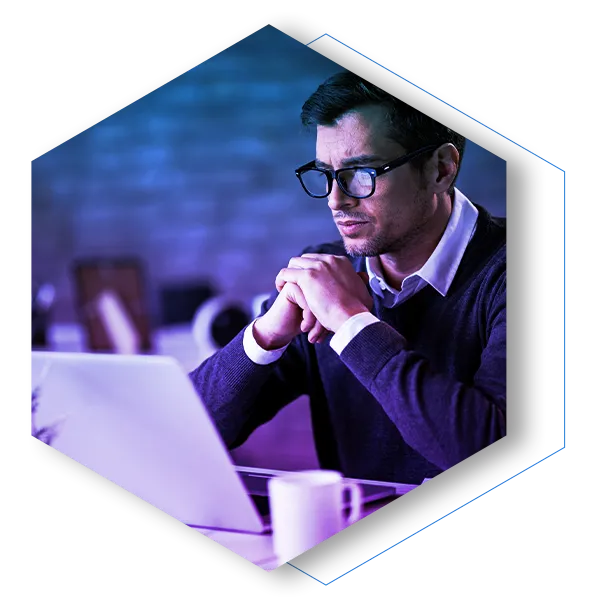 Serious businessman reading something on laptop while working in the office.