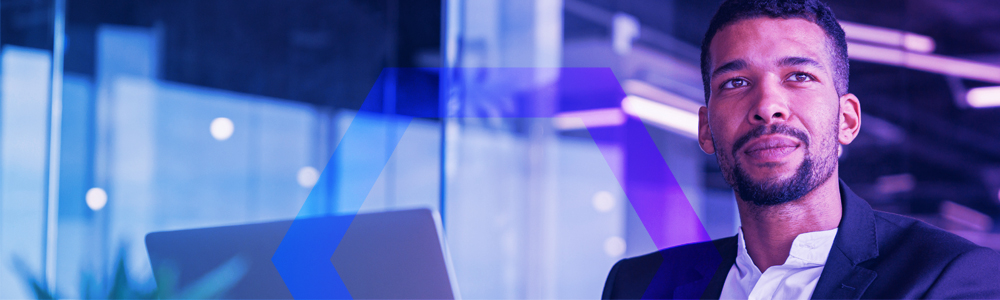 businessman working laptop and looking away while sitting in modern office