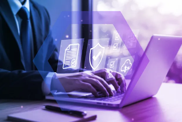  professional works on a laptop with holographic icons representing security policies, compliance, and cloud access. The image symbolizes the process of achieving a true Zero Trust architecture with a cloud-delivered enterprise browser.