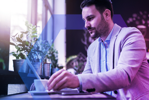 A professional working remotely on a laptop in a cafe, representing secure and seamless access to applications without a traditional VPN. The image visualizes how modern, cloud-native solutions can eliminate risk and performance bottlenecks for a hybrid workforce