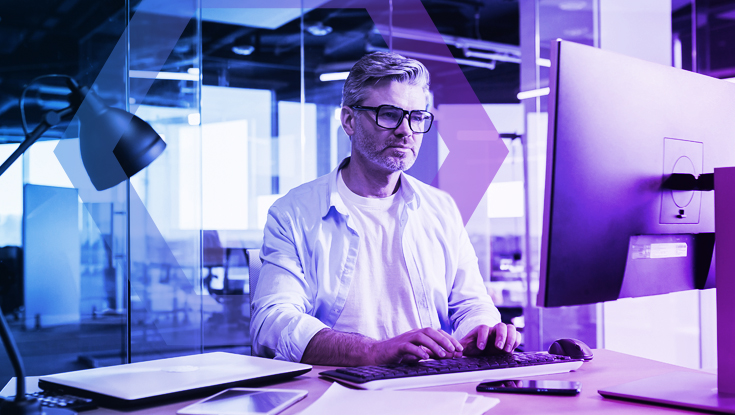 A focused IT professional working at a multi-monitor computer, representing the challenge of closing the browser security gap. The image symbolizes the need for modern solutions beyond traditional SWG to secure the web against new classes of attacks.