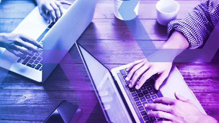 An overhead view of a team working on laptops, representing how administrators can define what content is captured in a session recording. This image symbolizes the granular details, like user inputs and page resources, that provide clear proof of user activity.