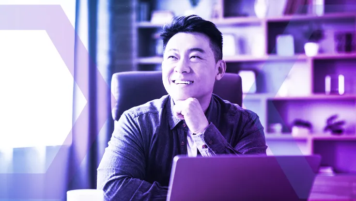 A smiling professional works on his laptop, representing the confidence and security of using the Menlo Secure Cloud Browser. The image symbolizes how executing all web traffic in the cloud completely separates the user's endpoint from web-borne malware and ransomware.