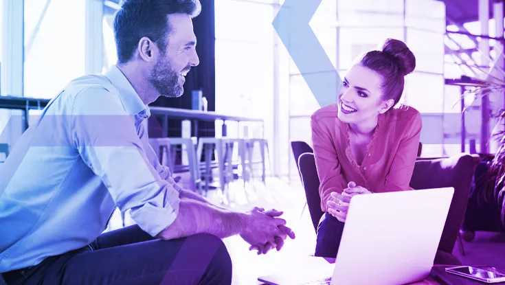 Two professionals collaborate confidently on a laptop, representing a secure work environment where weaponized documents are neutralized. The image symbolizes how Menlo's advanced file security strips malicious content and reconstructs 100% safe files, eliminating the risk of file-borne ransomware