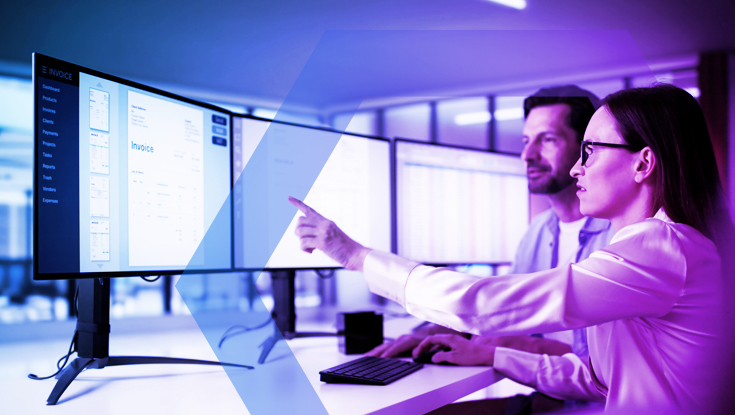 Two IT professionals collaborating in front of a large monitor, representing the simplified management and 'Massive Cost and Complexity Reduction' achieved by bypassing network bottlenecks. The image symbolizes the improved performance and efficiency for every user, anywhere.