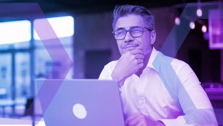 A thoughtful IT professional works securely on a laptop, representing the confidence that comes with Guaranteed Endpoint Security. The image symbolizes how a cloud-based protective barrier removes the endpoint as a threat vector, eliminating the need for complex VDI.