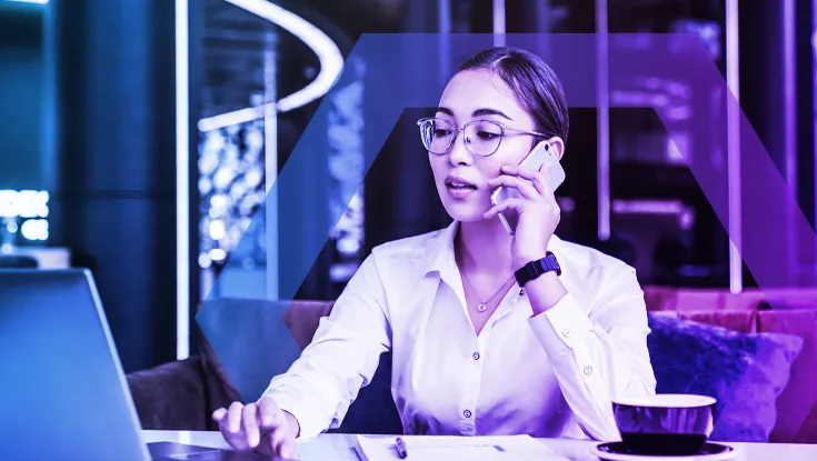 A professional works on a laptop in a modern office or travel lounge, representing the freedom and simplicity of Agentless Access. The image symbolizes seamless, secure access from any browser or device without the need for VPN hardware or client software