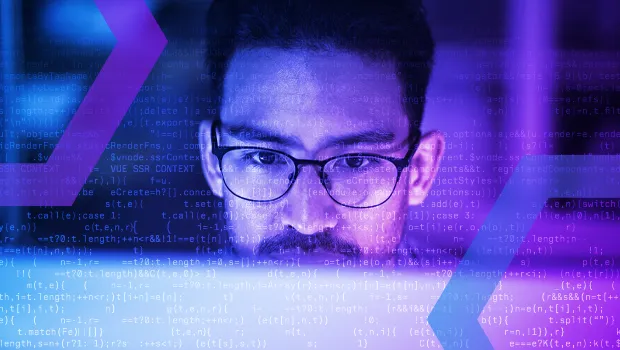 A security analyst looks intently at a screen, representing a secure cloud browser product. Lines of code are superimposed over the image, illustrating the complex security solution.