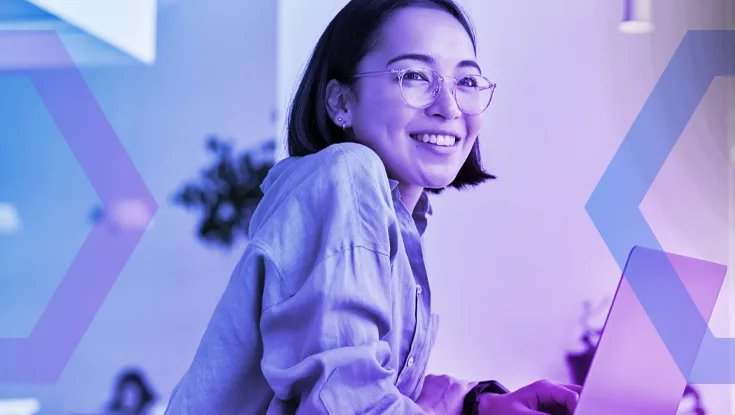 A smiling female employee with glasses works on her laptop, demonstrating user productivity. The image features a purple color overlay and geometric tech graphics, representing a secure and efficient modern workspace.
