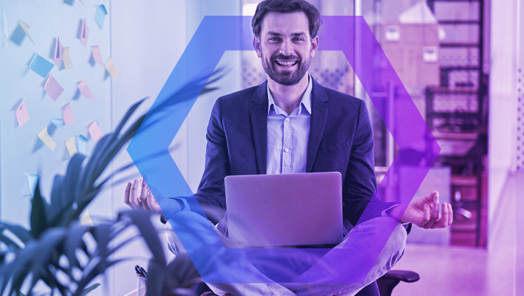 A smiling businessman sits cross-legged in a meditation pose on his office chair, holding a laptop. This symbolizes the peace of mind and stress-free productivity enabled by secure data and file protection, all framed by a blue and purple geometric overlay.