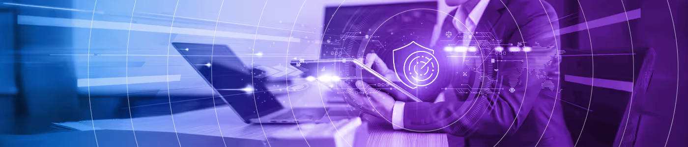 Person in business suit using a tablet with a laptop on a desk, overlaid with digital security and data protection graphics.