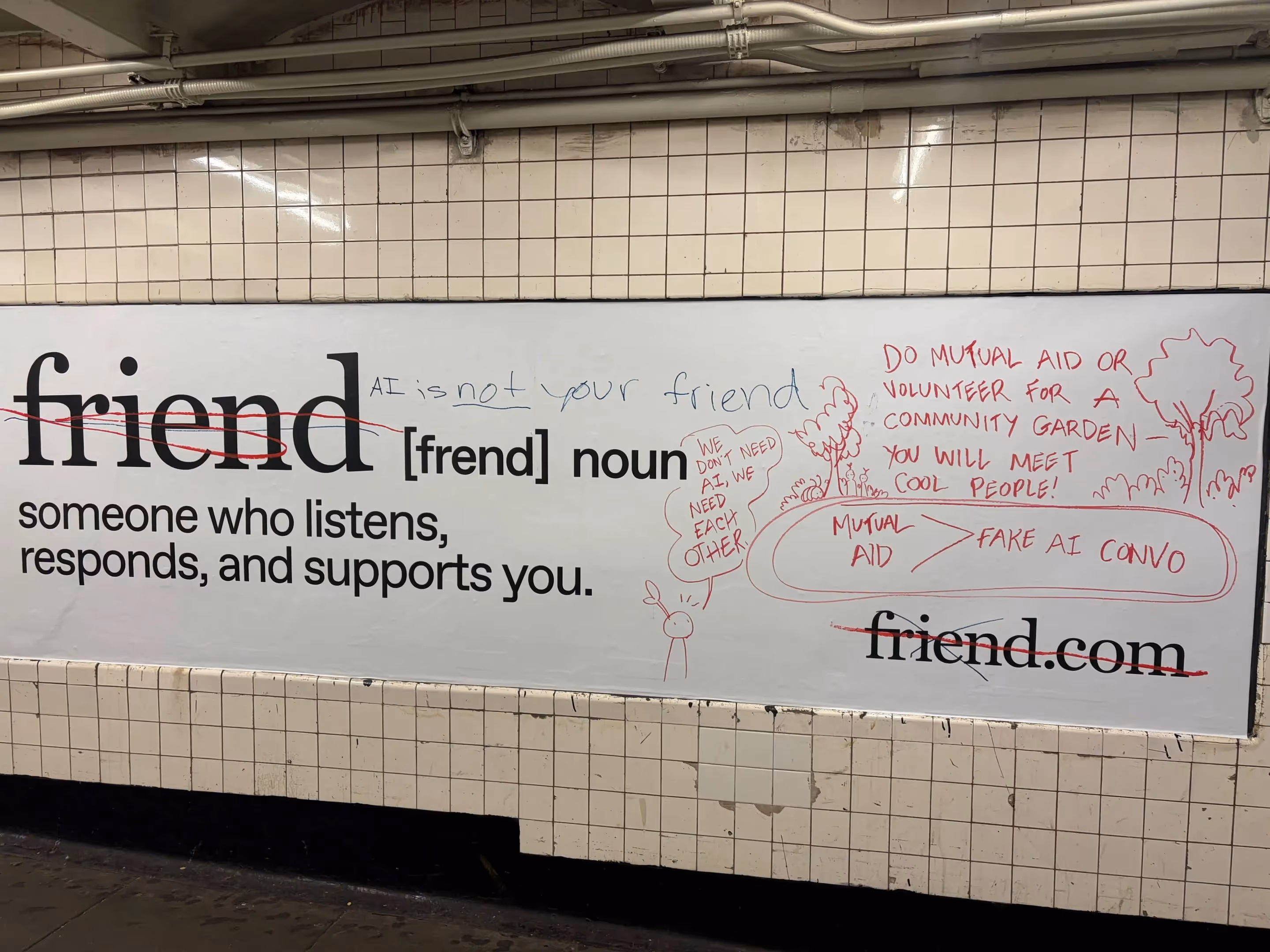 Vandalized New York City subway ad for the AI companion product “Friend,” with handwritten text like “AI is not your friend,” “We need each other,” and drawings promoting mutual aid.