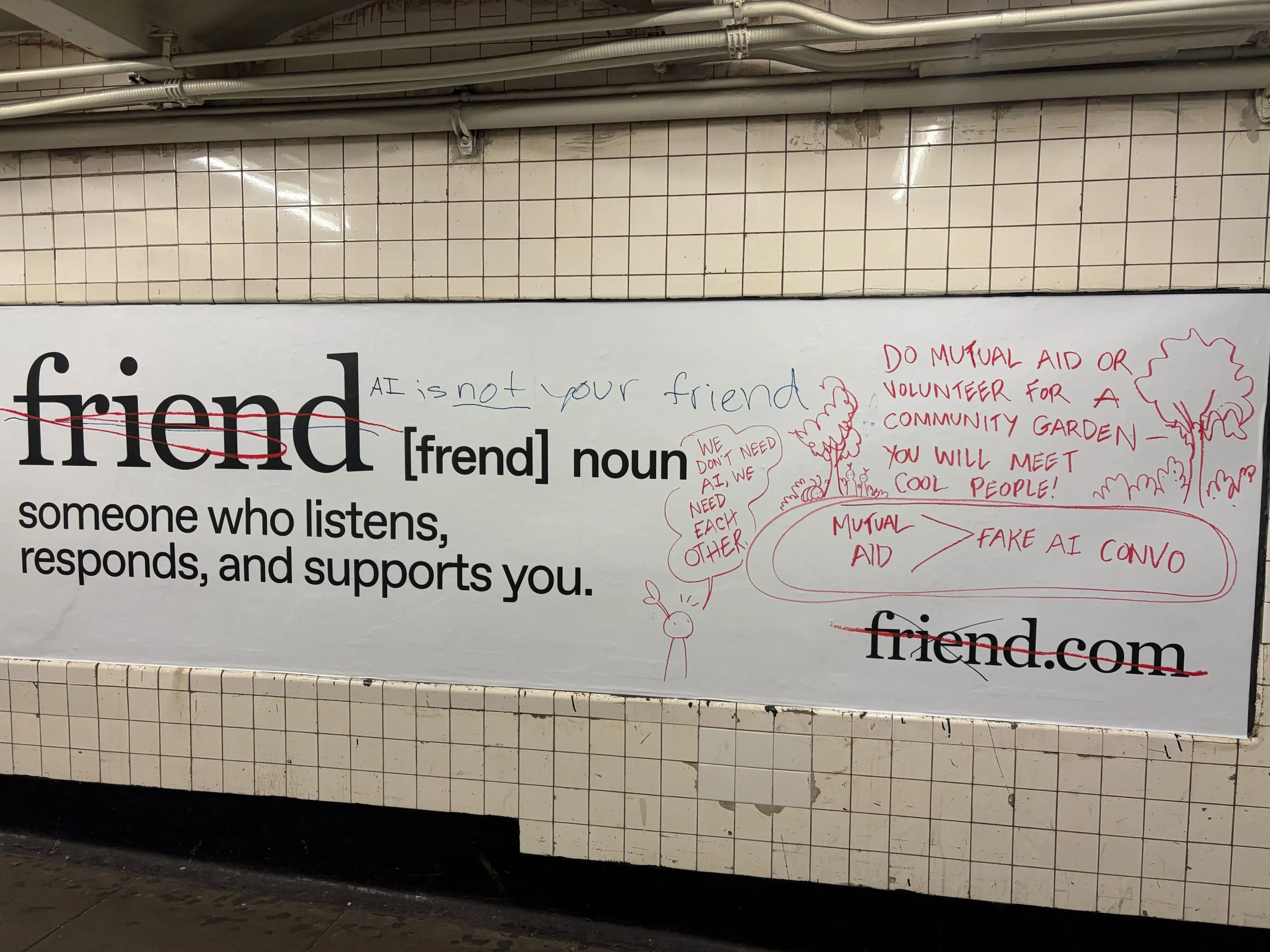 Vandalized New York City subway ad for the AI companion product “Friend,” with handwritten text like “AI is not your friend,” “We need each other,” and drawings promoting mutual aid.