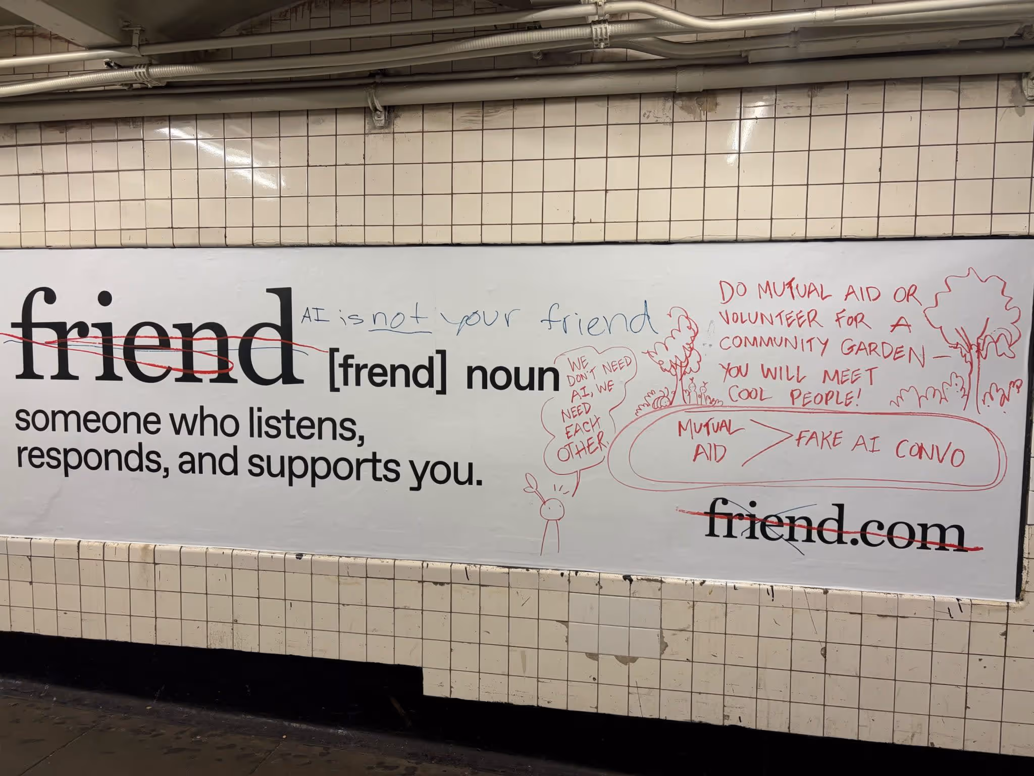 Photo of a vandalized subway ad for the AI companion Friend. The word “friend” is crossed out and replaced with graffiti that reads “AI is not your friend,” “We don’t need AI, we need each other,” and messages promoting mutual aid over AI conversations.