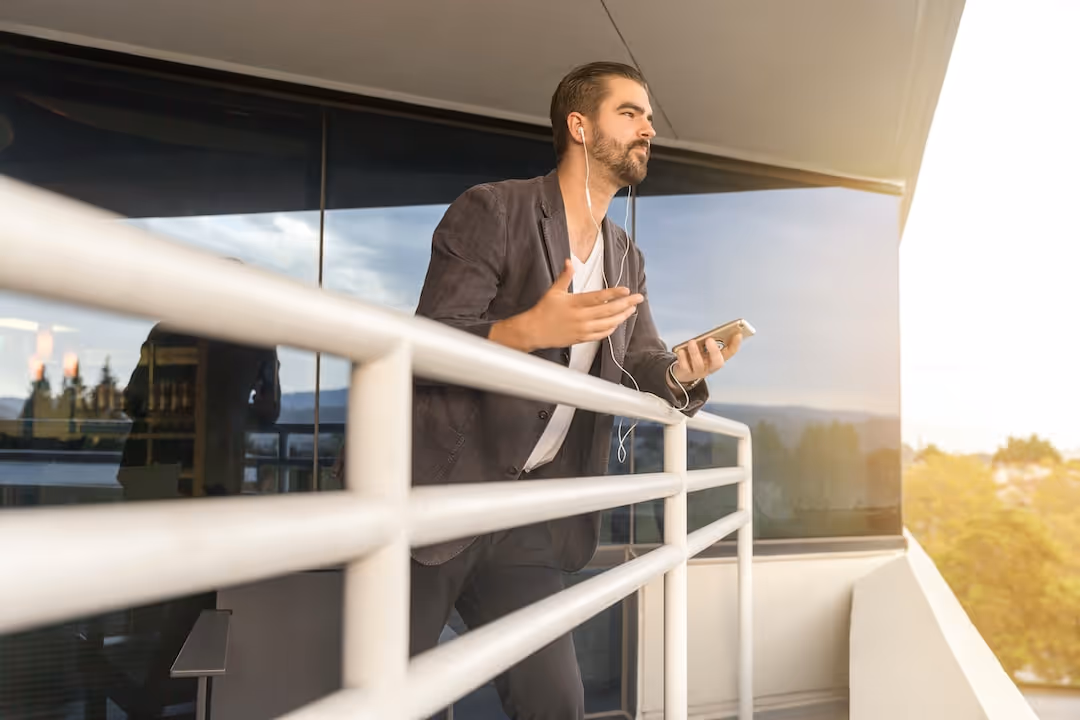 man leaning on white metal rail