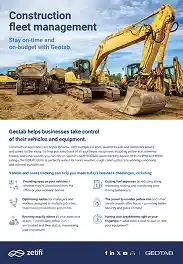 Yellow construction excavators lined up on a dirt site under a blue sky with clouds.