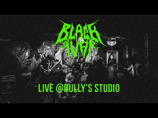 Black and white photo of a live band performing with green text overlay reading 'BLACK IVAR' and 'LIVE @BULLY'S STUDIO'.